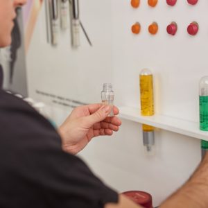 Male hairdresser choosing haircare products at beauty salon